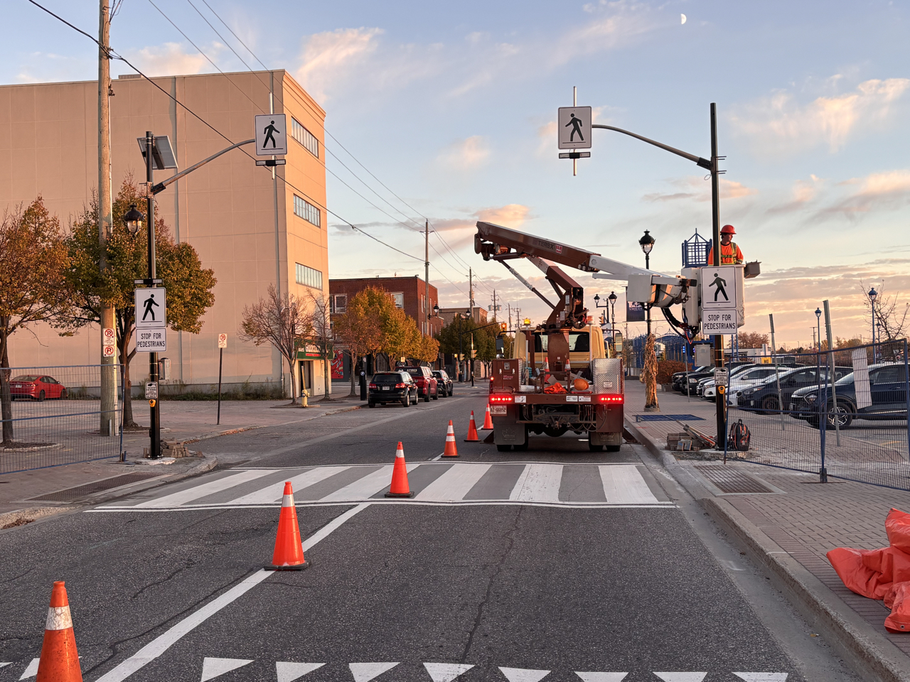 Crews work on a pedestrian crossing signal.